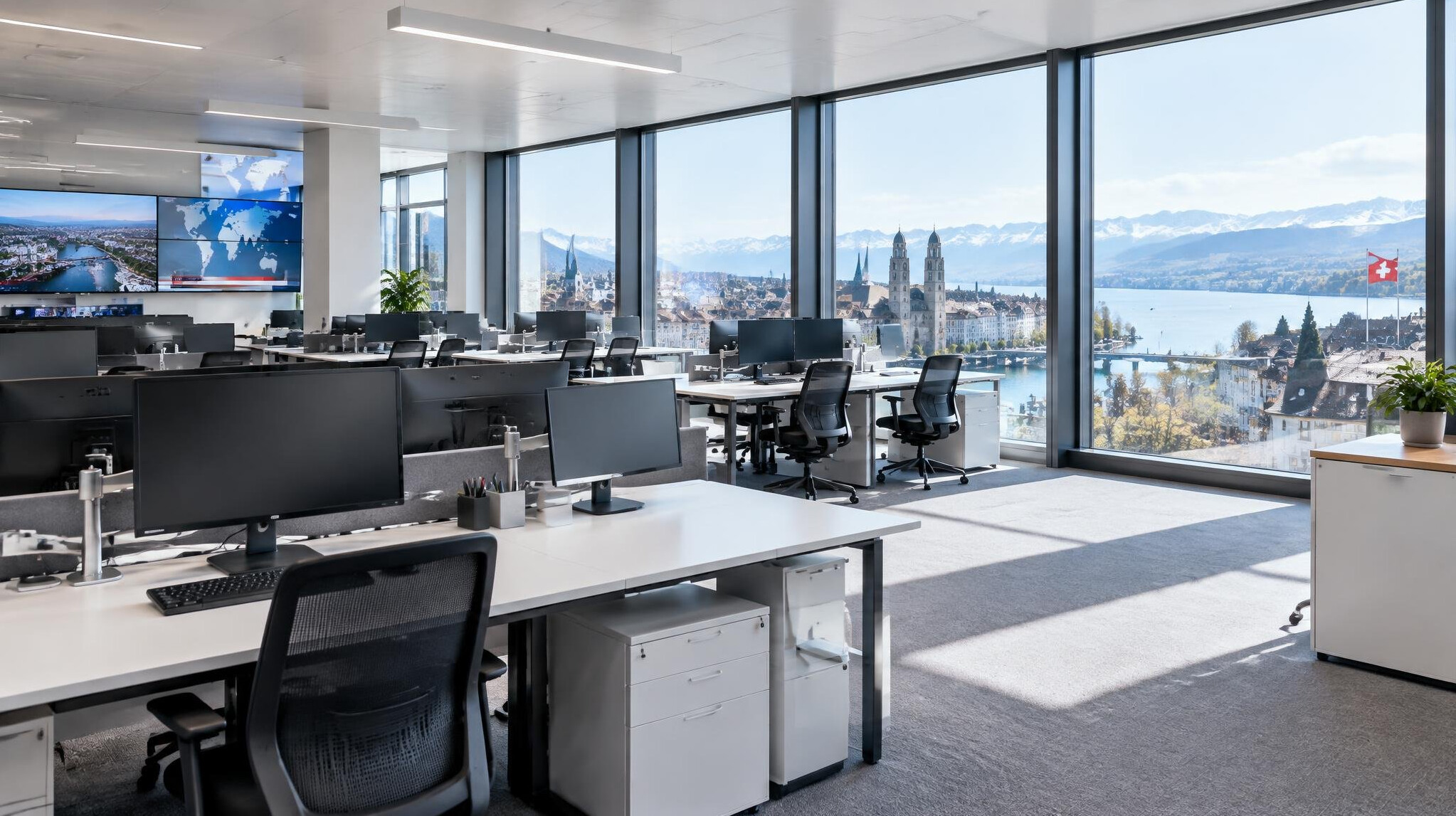 Bright open-plan newsroom office with desks and large windows